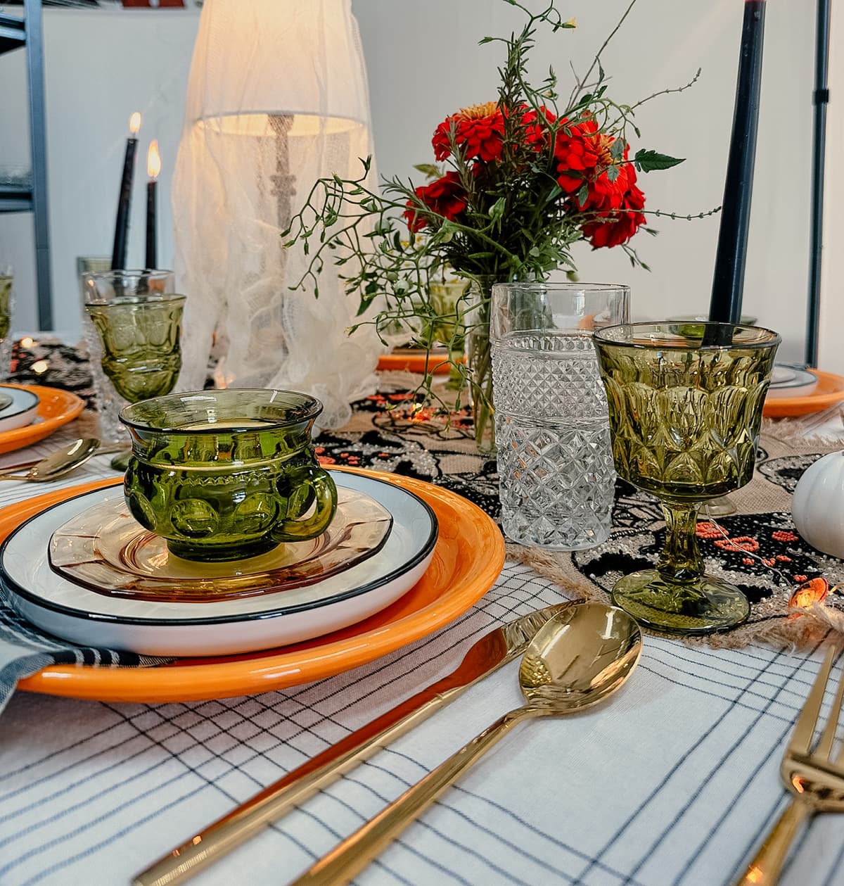 Spooky holiday indoor table setting with vintage tableware and warm decor for intimate gathering in Bakersfield