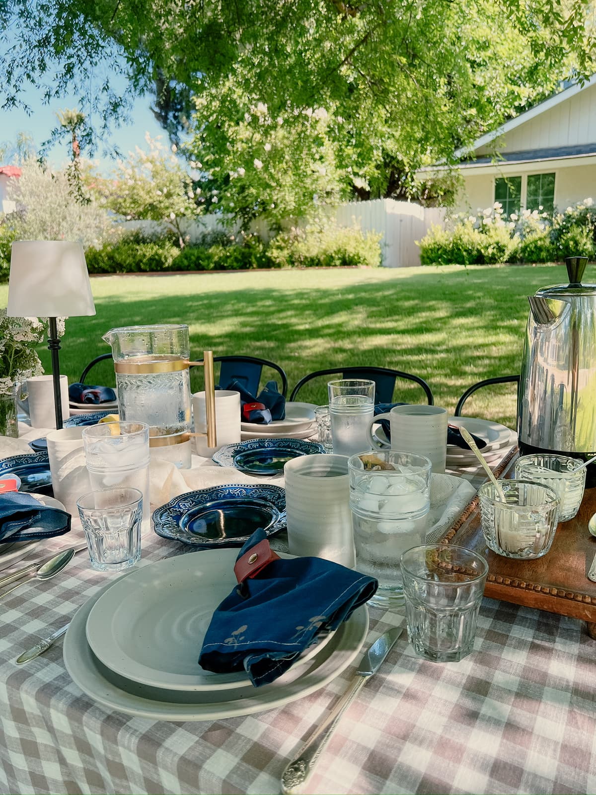 Elegant blue outdoor table setting with vintage tableware and natural surroundings for intimate gathering in Bakersfield